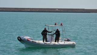 Two Tunisian Coast Guards on board a boat