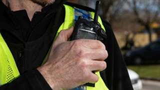 Stock image of officer on radio