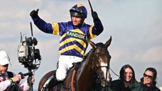 Derek Fox celebrates on Corach Rambler after winning the 2023 Grand National