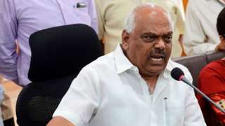 K.R. Ramesh Kumar reacts while addressing a press conference in Bangalore on July 28, 2019