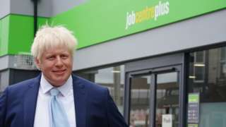 A wax figure of Boris Johnson outside a jobcentre