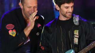 Chris Martin and Guy Berryman of Coldplay on stage in London in October 2021