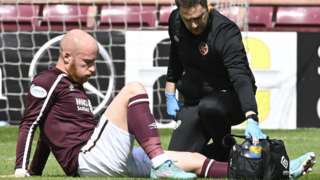 Hearts striker Liam Boyce receives treatment