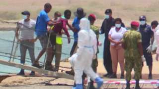 A survivor is helped ashore in Senegal