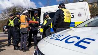Police officers arrest a climate change protestor in Thurrock