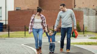 Family walking in the road