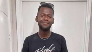 Handout image from police showing Tyreece Scott standing in front of a door with sunglasses on his head