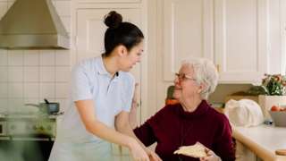 Elderly lady with home carer