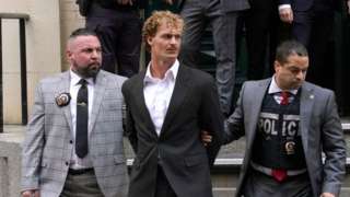 Daniel Penny leaves police station in handcuffs