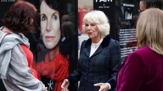 The Duchess of Cornwall stands next to the I Am exhibit