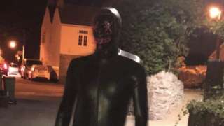 Man in gimp outfit
