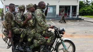 Four soldiers riding a motorbike in Palma
