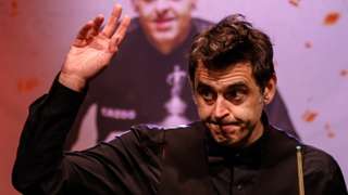 Ronnie O'Sullivan waves to the crowd at the Crucible