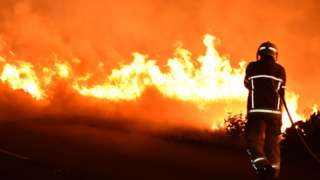 A firefighter tackles a fire in Pontefract in August 2022