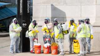 Cleaning workers in hazmat gear
