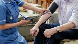 Stock image of an elderly patient receiving care in their home