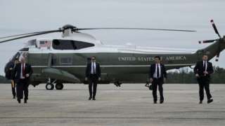 Members of the Secret Service arrive to board Air Force One to escort US President Donald Trump at Andrews Air Force Base in Maryland.