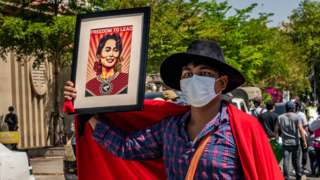 A Protesters holds a portrait of de-facto leader Aung San Suu Kyi in front of the Chinese Embassy on February 11, 2021 in Yangon, Myanmar