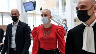 Mila (C) arrives in court during the opening of the trial