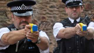 Two police officers using Taser guns
