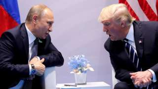 Putin and Trump sit across from each other