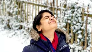 A person looking up at snow