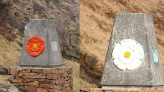 Marker stones with the Red Rose of Lancaster and the White Rose of York on the M62
