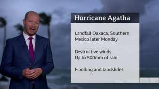 Darren Bett standing in front of a chart with details about Hurricane Agatha