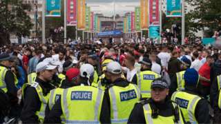 Police officers patrol outside Wembley Stadium before the Euro 2020 final between Italy and England