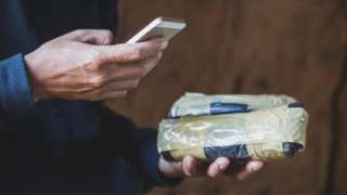 A drug dealer using a mobile phone