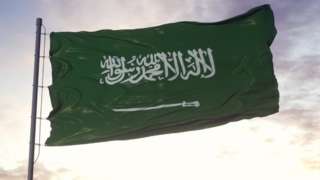 Saudi flag against cloudy sky
