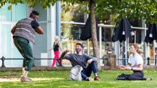 Friends meeting outside socially distanced