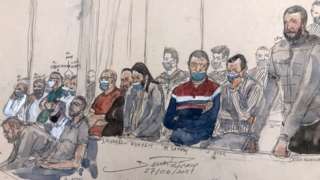 Salah Abdeslam (R) standing next to the 13 other defendants in front of Paris' criminal court during the trial of the November 2015 attacks on 27 June