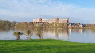 A factory reflected in water