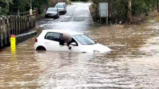 A car stuck in the Rufford Lane ford in Nottinghamshire