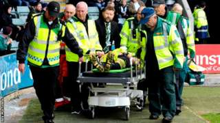 Referee Kevin Johnson being taken to an ambulance on a stretcher after being injured in a collision with Jimmy Spencer