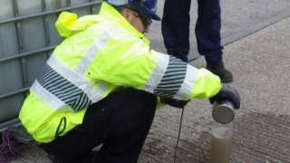 Environment Agency officers taking a water sample