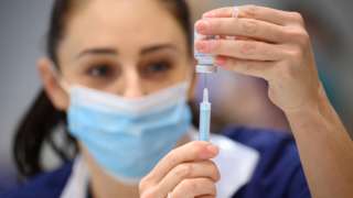 A nurse prepares a Covid vaccine