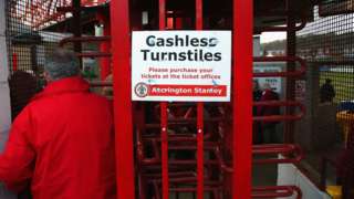 A fan goes through the turnstiles at Accrington Stanley