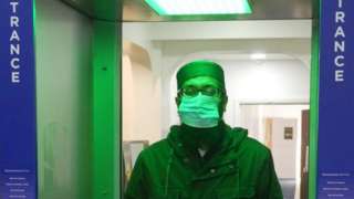 Man walking through sanitiser in mosque