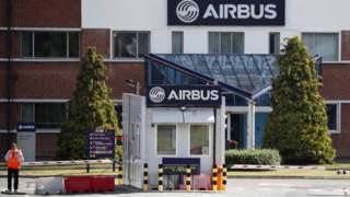 A security guard standing outside Airbus in Broughton, Flintshire
