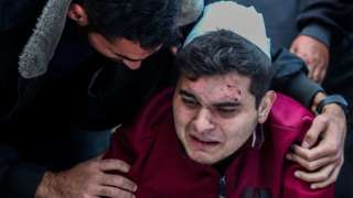 People mourn as they collect the bodies of Palestinians killed in Khan Younis, Gaza on December 04, 2023