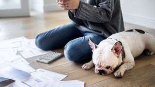 Woman and dog with bills