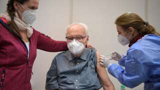 Werner Boestfleisch, 86, receives a dose of the Pfizer-BioNTech vaccine at the Metropolis-Halle vaccination centre in Potsdam, Germany, January 5, 2021