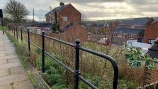 The planned site, an area of green space between houses