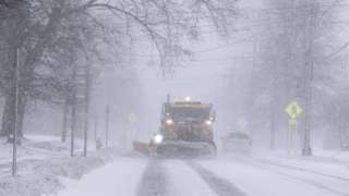 A snowplough on a street in Springville, New York on 23 December 2022