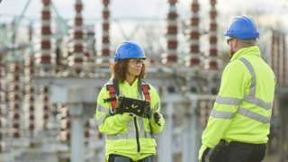 Workers at electricity substation