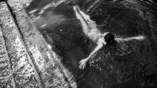 A woman floats in open water