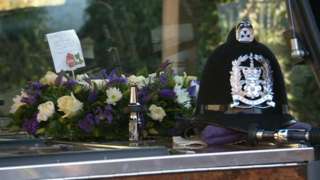 PC Dixon's coffin and police helmet