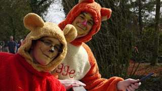 Two people dressed as Pooh and Tigger